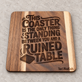 Individual square wooden coaster engraved with Ruined Table design