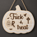 Trick or Treat Pumpkin engraved wooden sign with light border, photographed with lights off